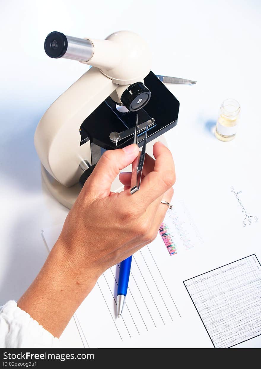 Microscope and doctor on white background