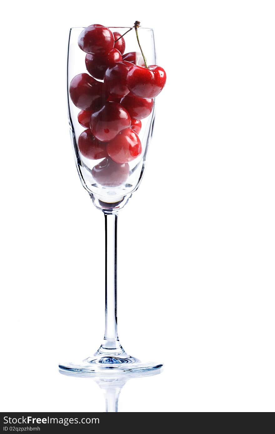 Cherries in a champagne glass on white background