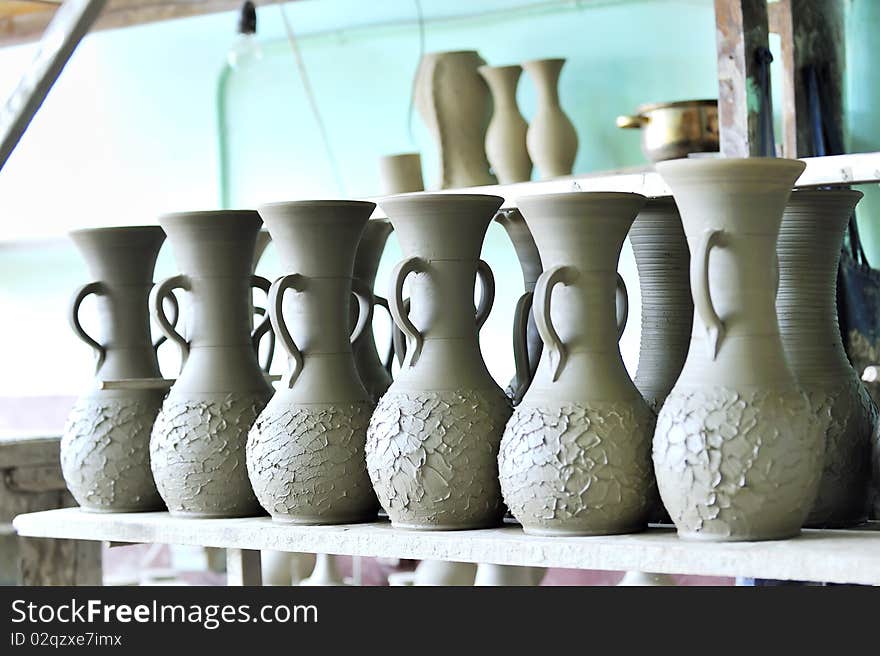 Drying ceramic vase inside of workshop on shelf