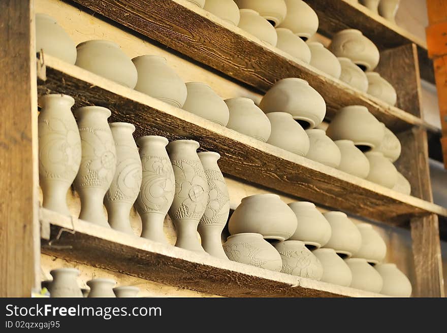 Drying ceramic vase inside of workshop