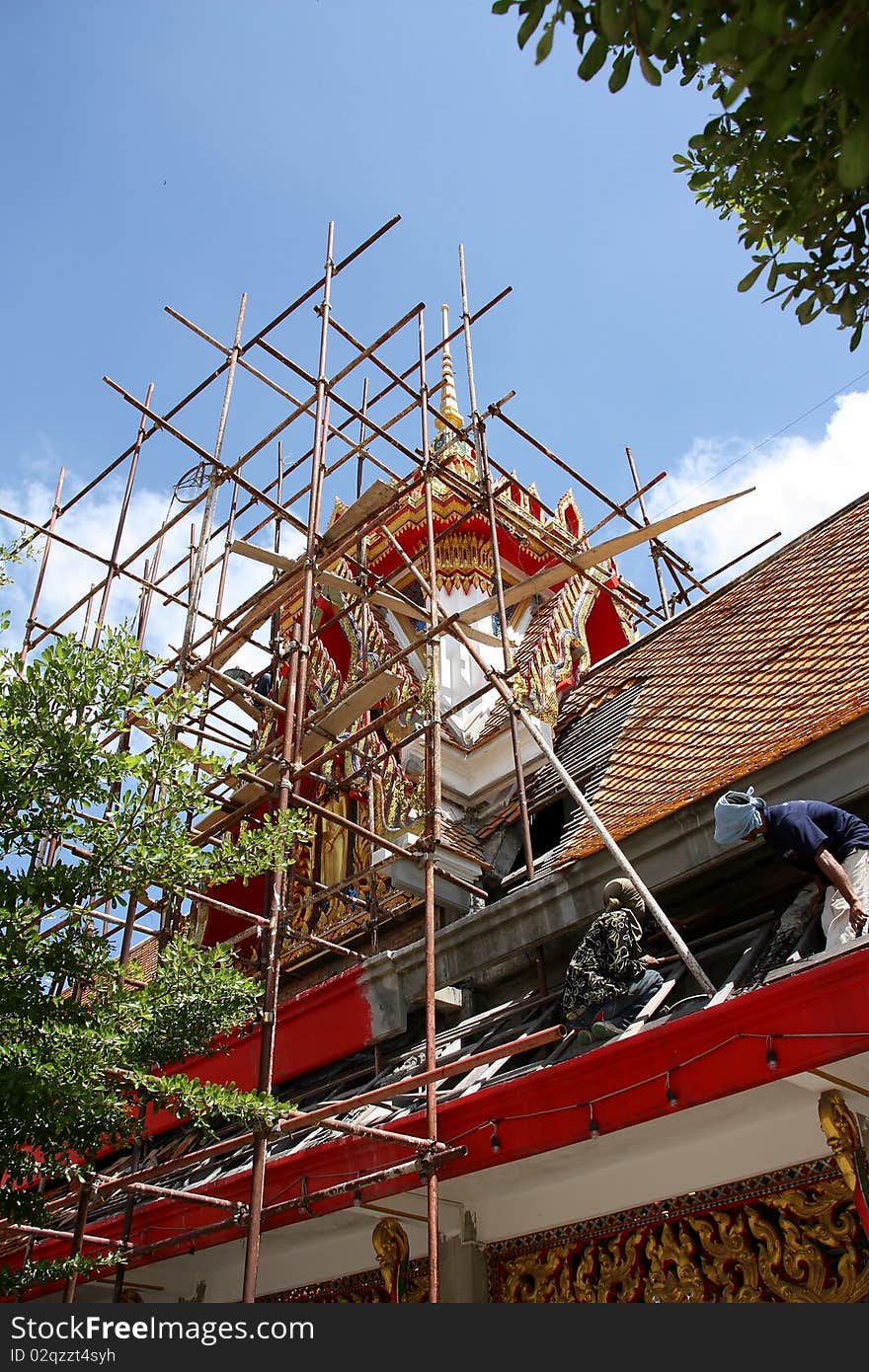 The worker working on the roof of temple. The worker working on the roof of temple.