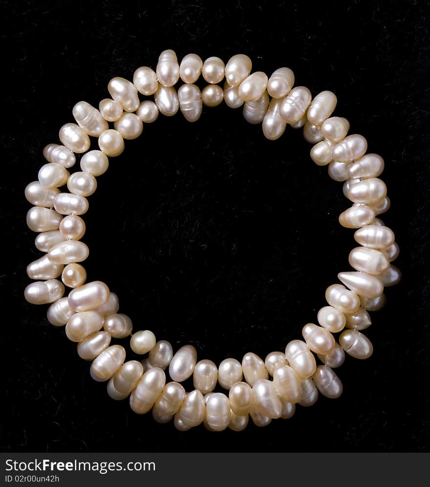 Pearl bracelet over black velvet