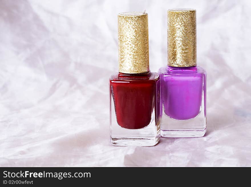 Two nail polish bottles over white background