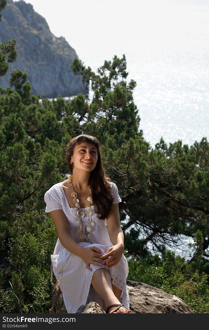 Young girl in white dress on the nature background