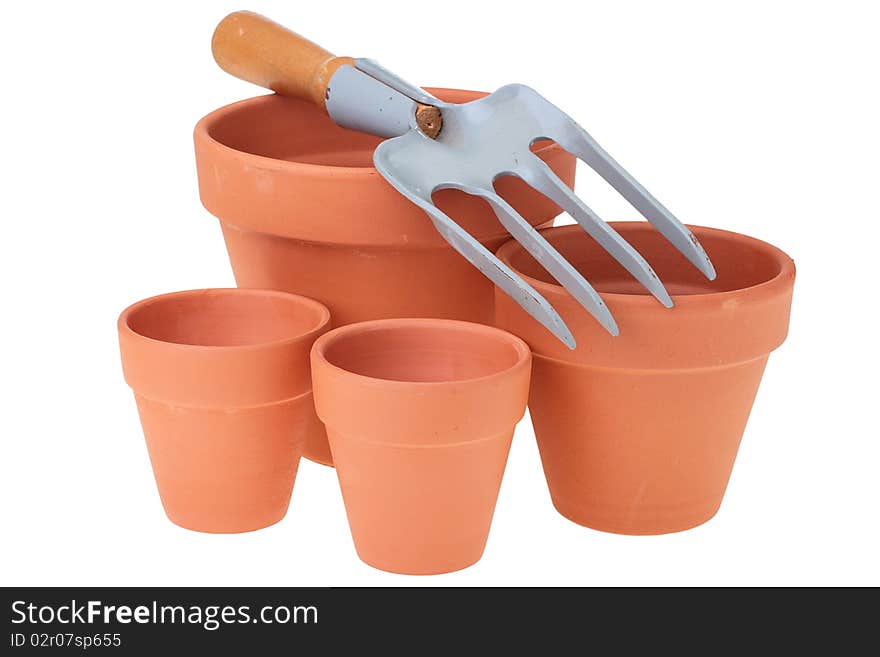 Steel rake on white background near to ceramic pots. Steel rake on white background near to ceramic pots.