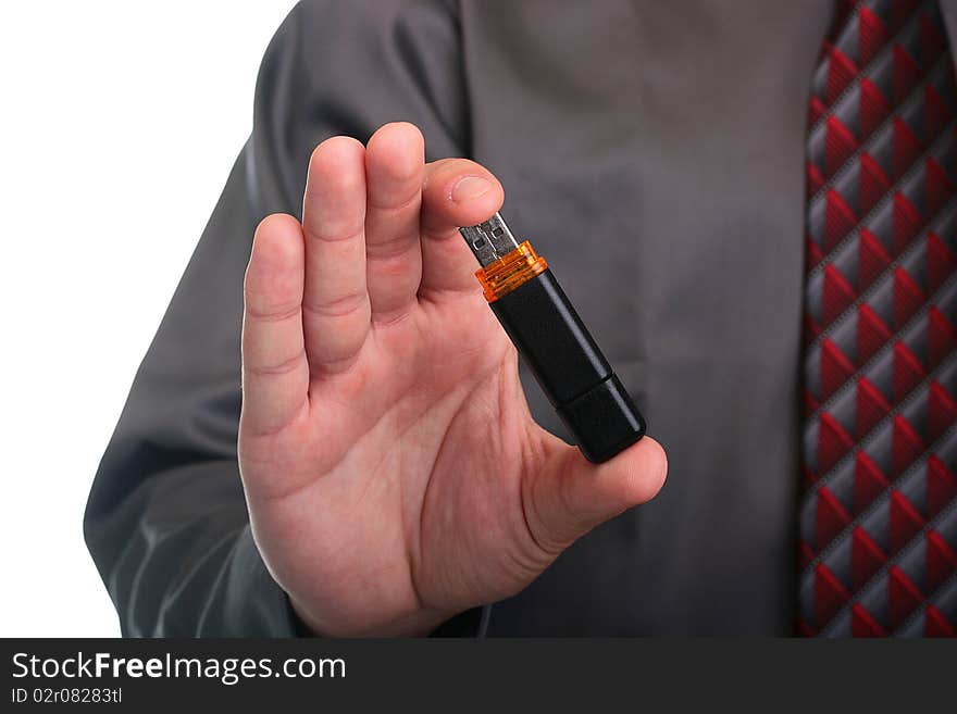 The businessman in a grey shirt and a tie stretches a memory stick. The businessman in a grey shirt and a tie stretches a memory stick.