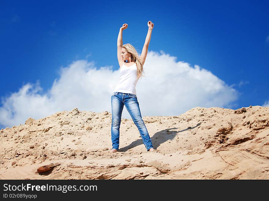 Young beautiful girl against the dark blue sky