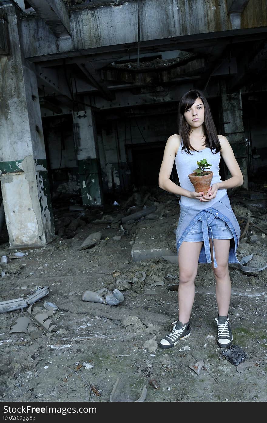 Concerned teenager holding flower pot