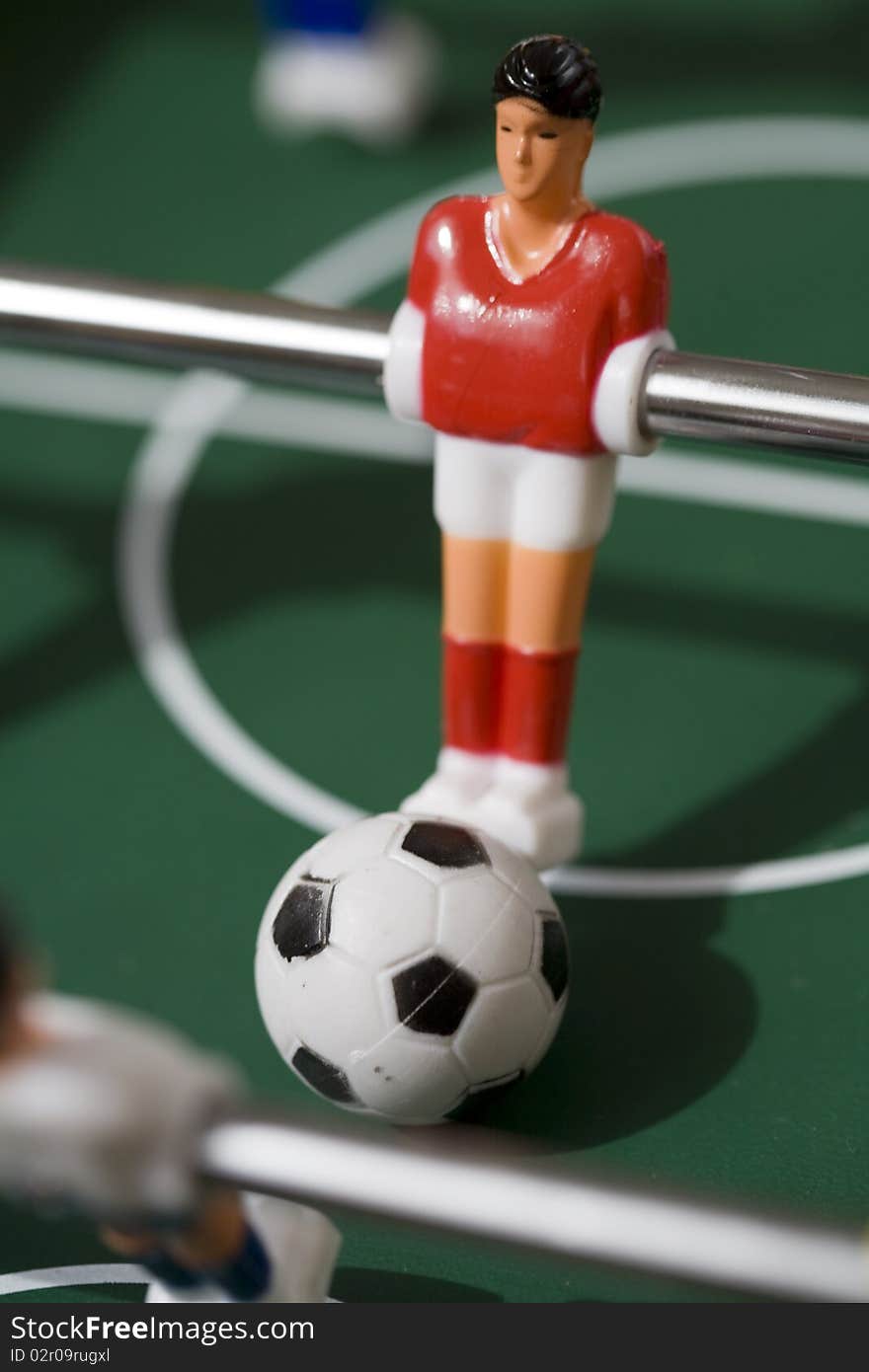 Playing tabletop soccer with red and yellow figures