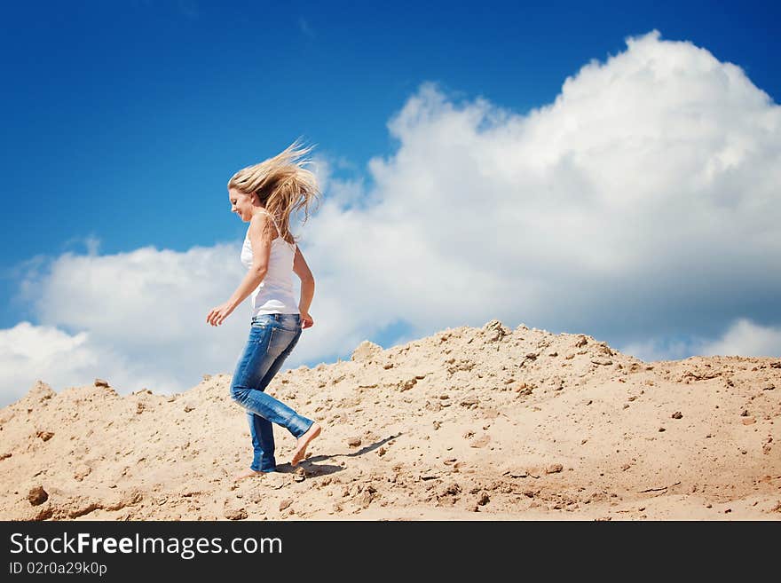 Young beautiful girl against the dark blue sky