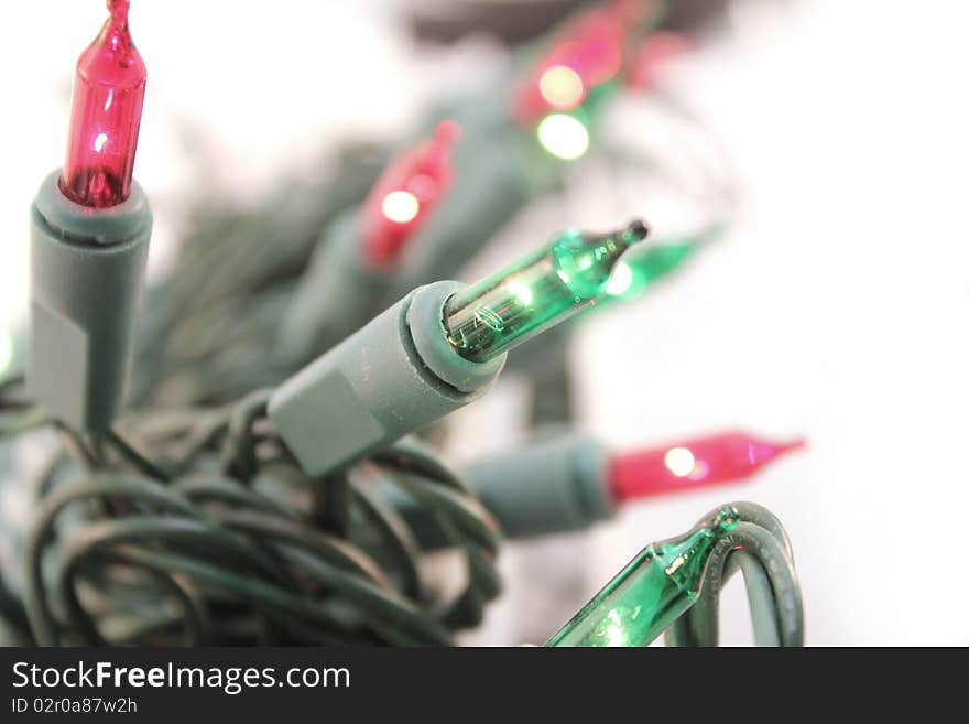 Red and green christmas light over white background. Red and green christmas light over white background