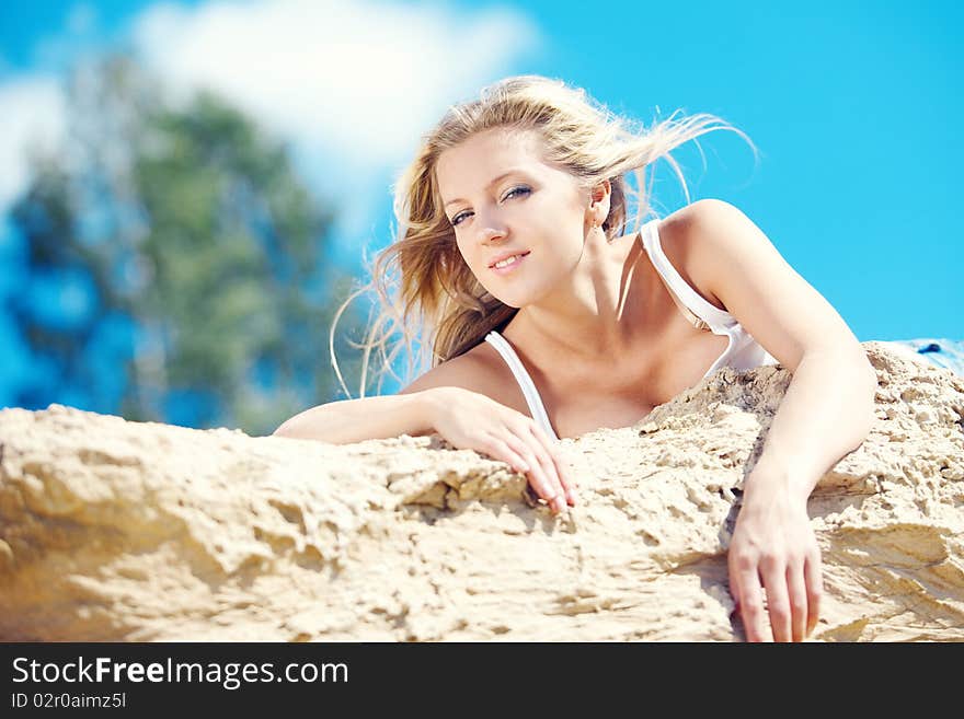 Young beautiful blonde with developing on a wind hair