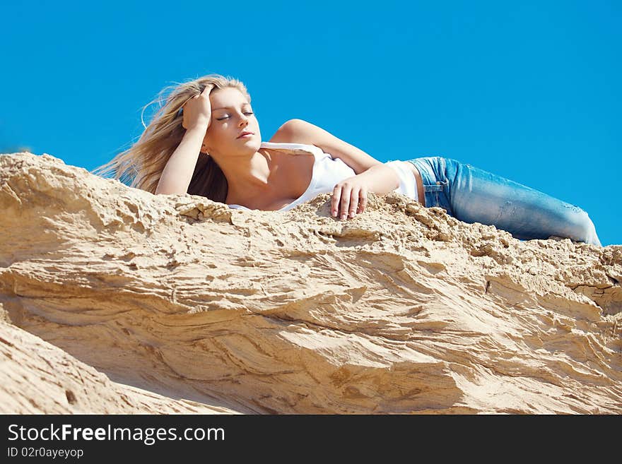 Young beautiful blonde with developing on a wind hair