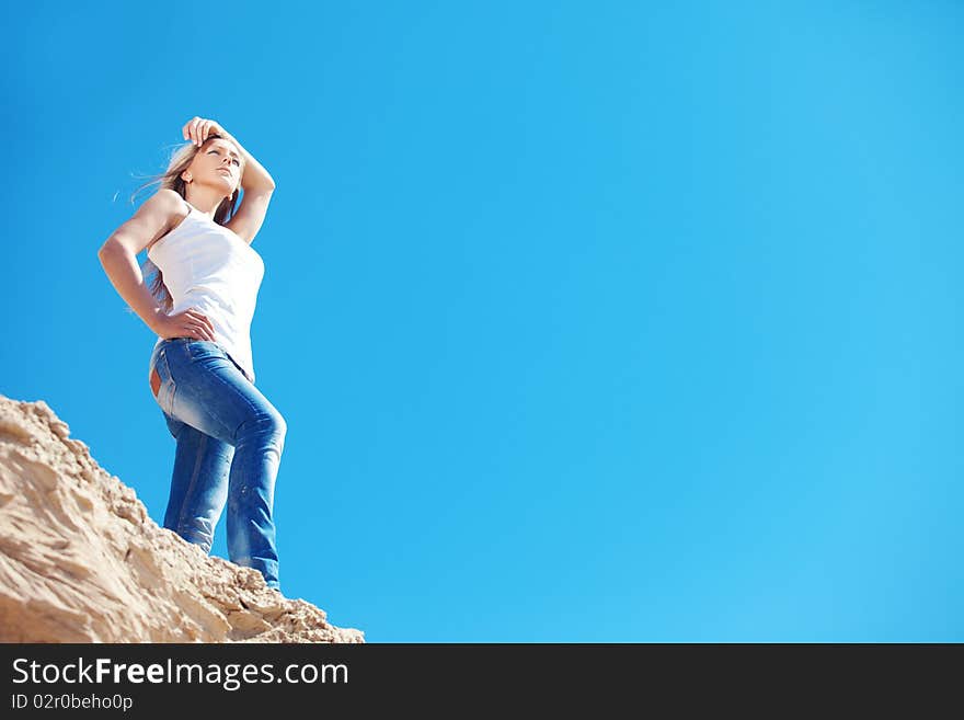 Young beautiful girl against the dark blue sky