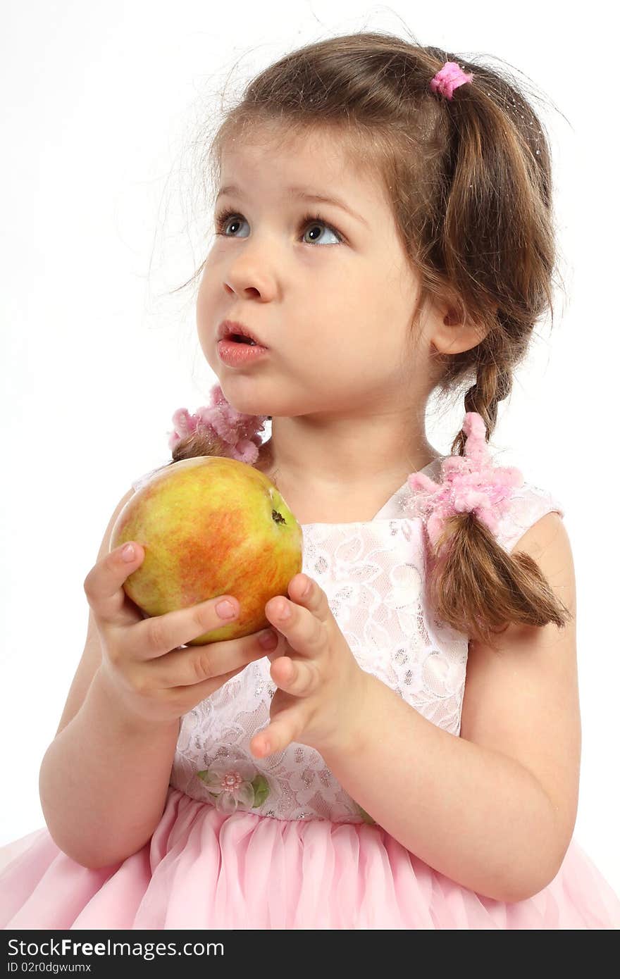 Child with pigtails eating ripe apple