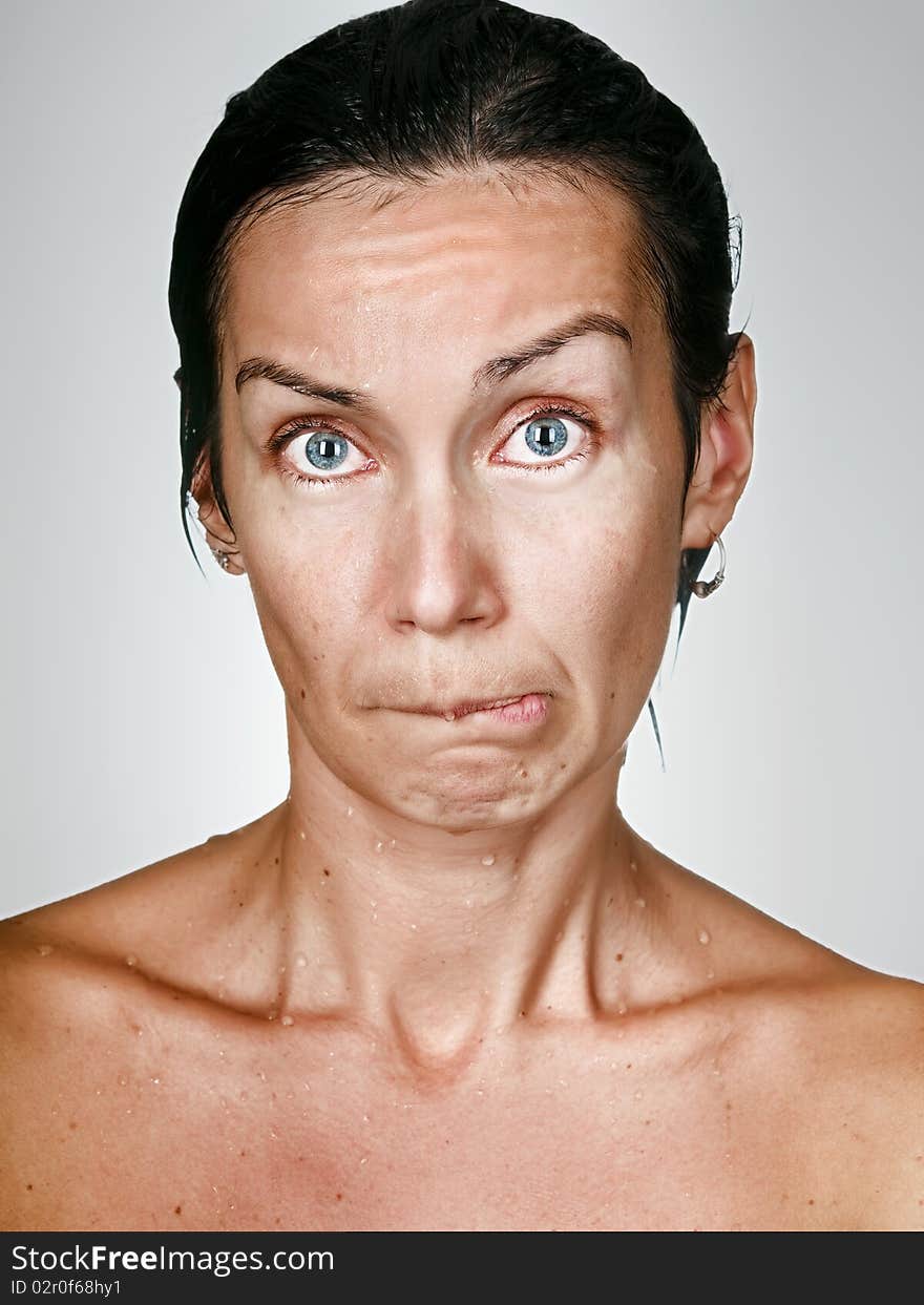 Facial portrait of offended woman with drops on a skin. Facial portrait of offended woman with drops on a skin