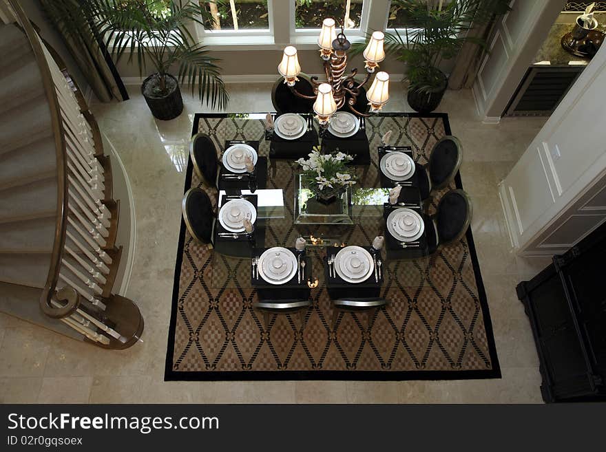 Dining room table with luxurious tableware and decor.