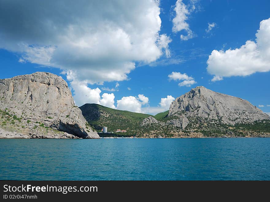 Green bay of Noviy Svet is located between two mountains. It is photographed from the sea. Green bay of Noviy Svet is located between two mountains. It is photographed from the sea.