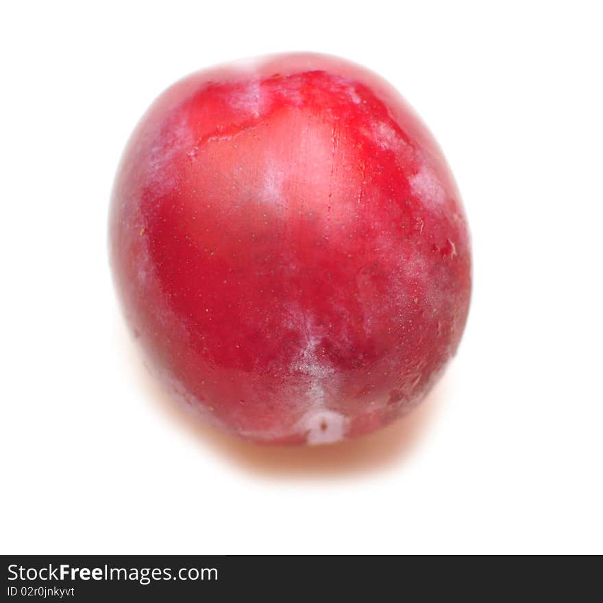 One plum on a white background, isolation. One plum on a white background, isolation