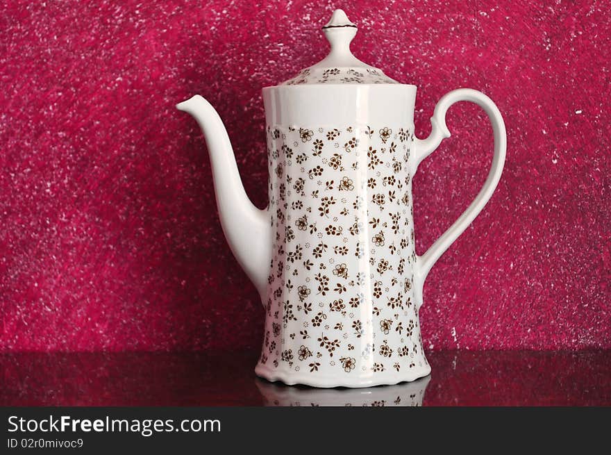 Image of a beautiful teapot on magenta background