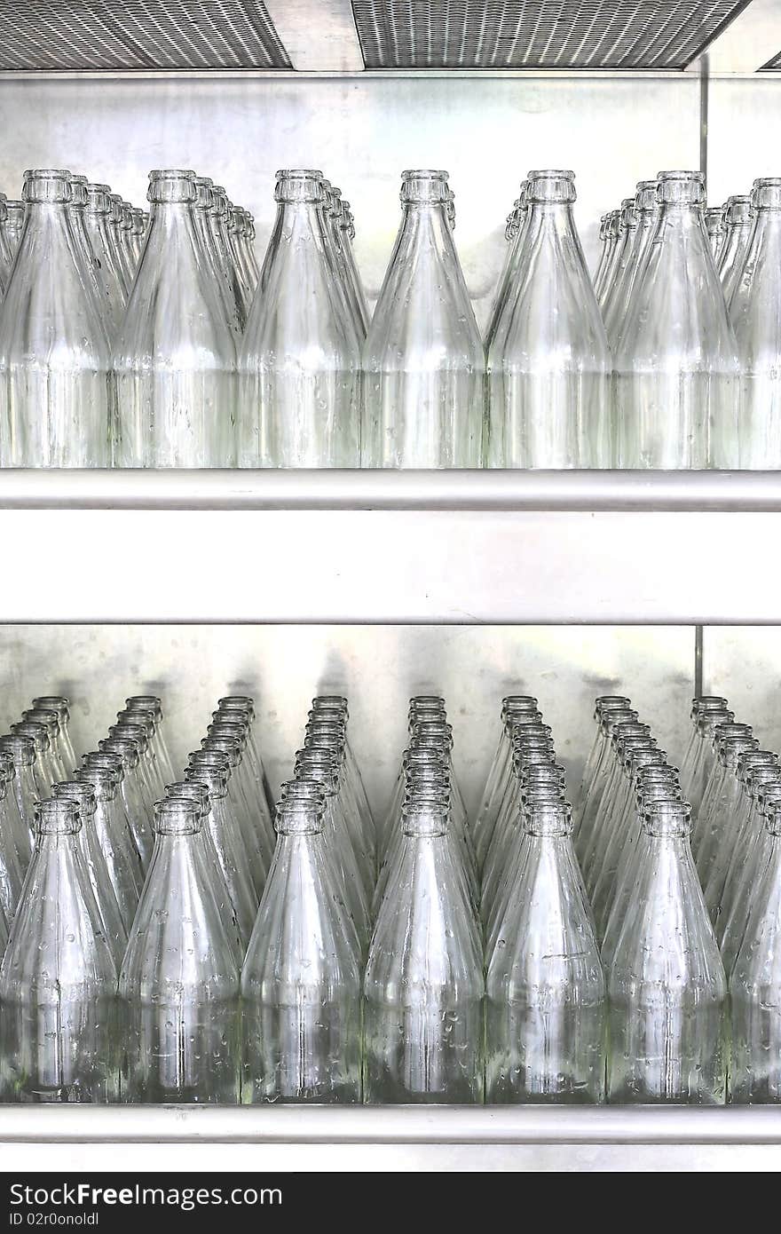 Glass transparent empty bottles assembly line. Glass transparent empty bottles assembly line