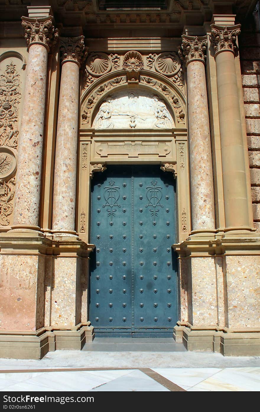 Blue steel door and marble columns closeup. Blue steel door and marble columns closeup