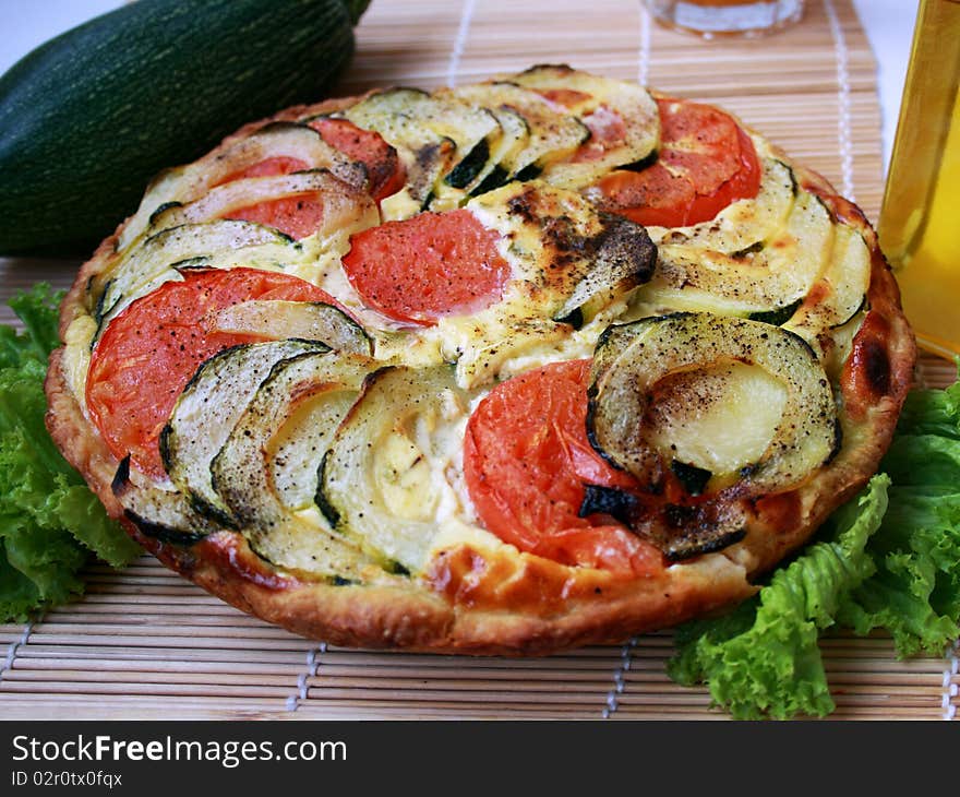 Shows summer pie with zucchini and tomatoes. Shows summer pie with zucchini and tomatoes