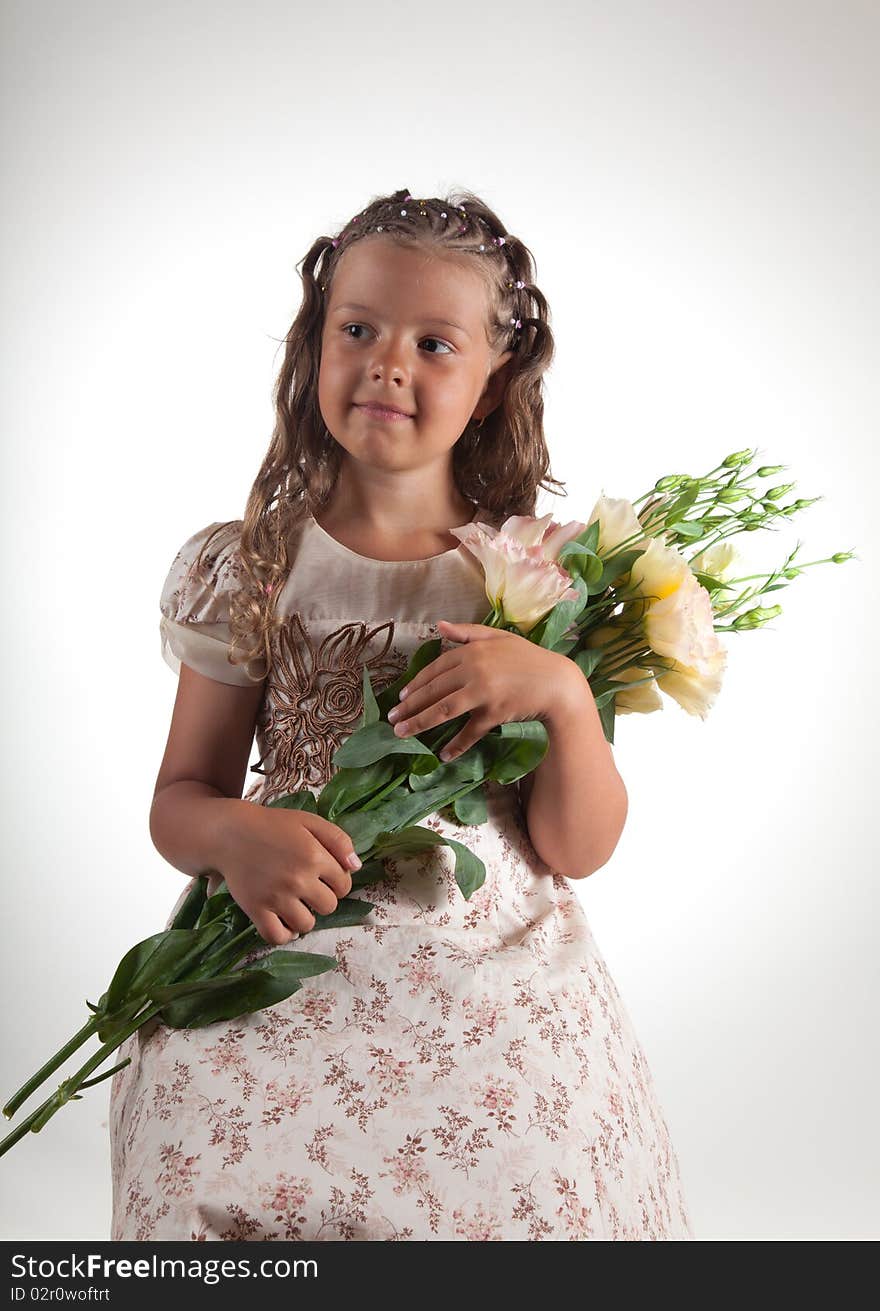 Cute little girl with pigtail hairstyle holding flowers, studio shot. Cute little girl with pigtail hairstyle holding flowers, studio shot