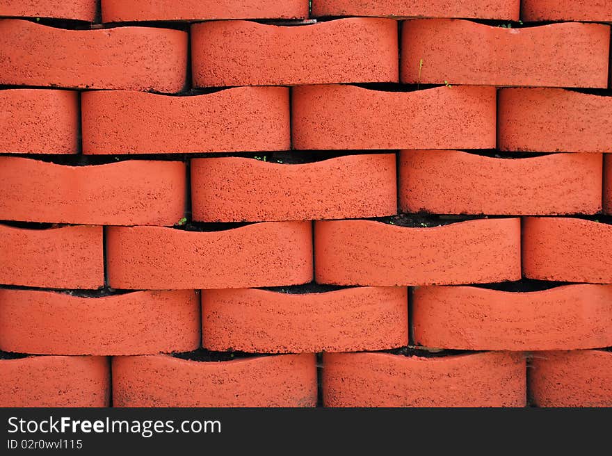 Red Terracotta Brick Wall Background with Soil and Plant