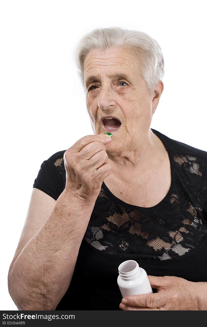 A senior woman with pills in her hand. A senior woman with pills in her hand