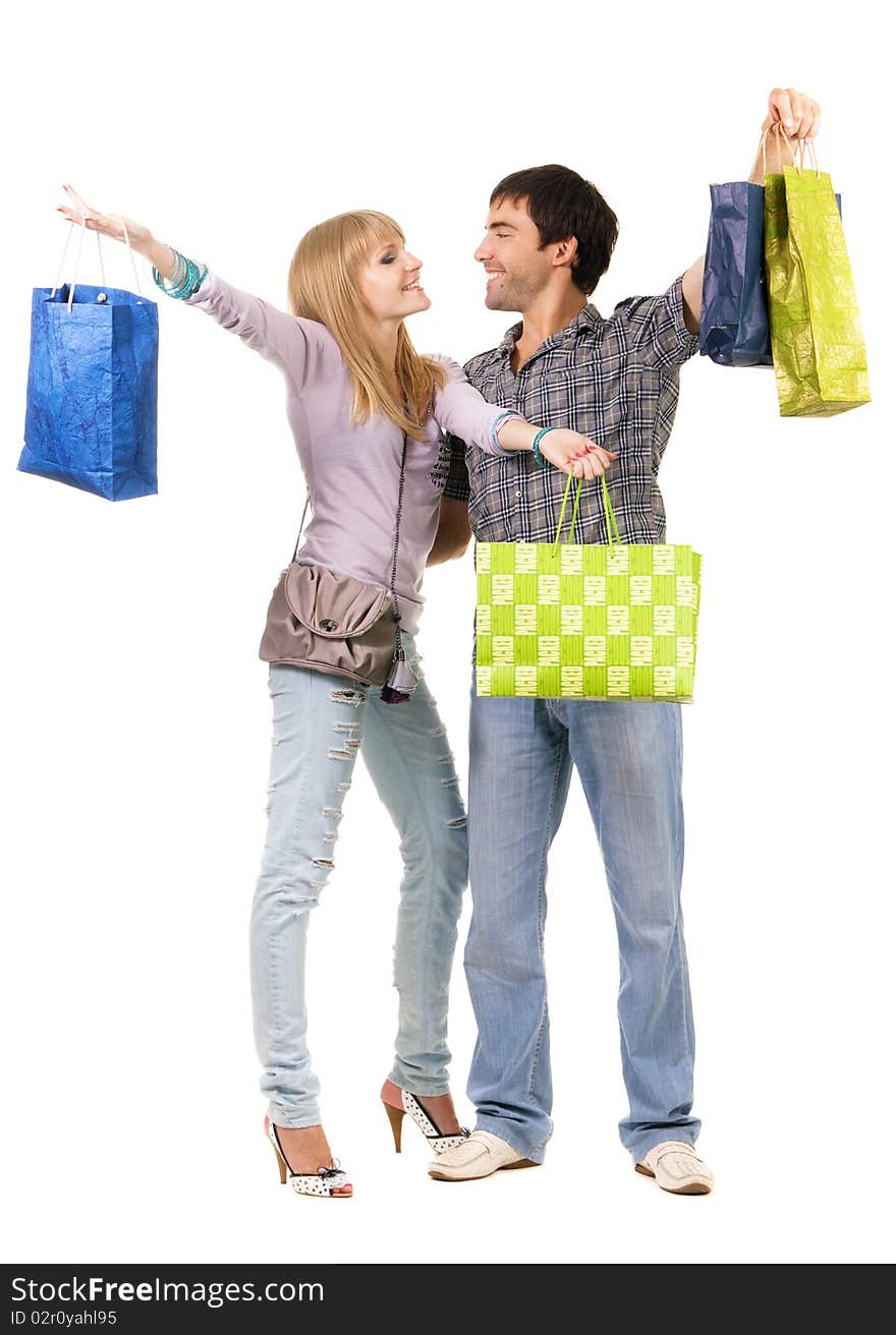 Beautiful young couple with shopping bags, isolated on white background