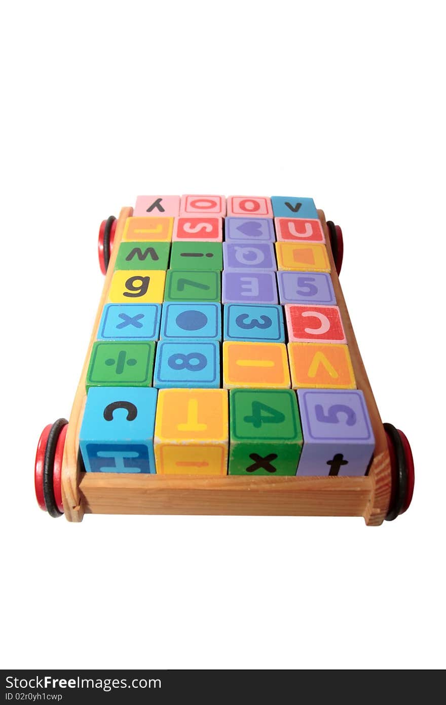 Childrens toy letter building blocks all together in a toy cart isolated on white background with clipping path. Childrens toy letter building blocks all together in a toy cart isolated on white background with clipping path