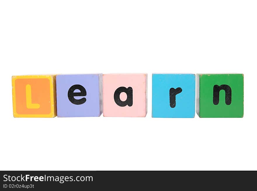 Assorted childrens toy letter building blocks against a white background that spell learn with clipping path. Assorted childrens toy letter building blocks against a white background that spell learn with clipping path