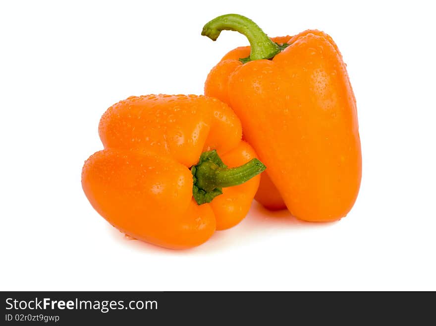 Orange paprika with drops of water, isolated on white background