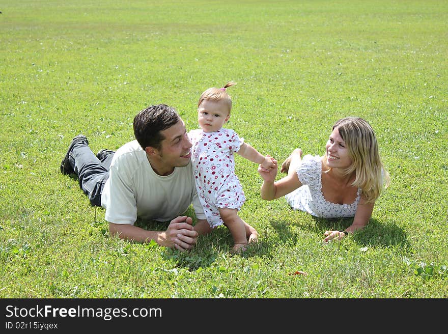 Happy family on the green grass