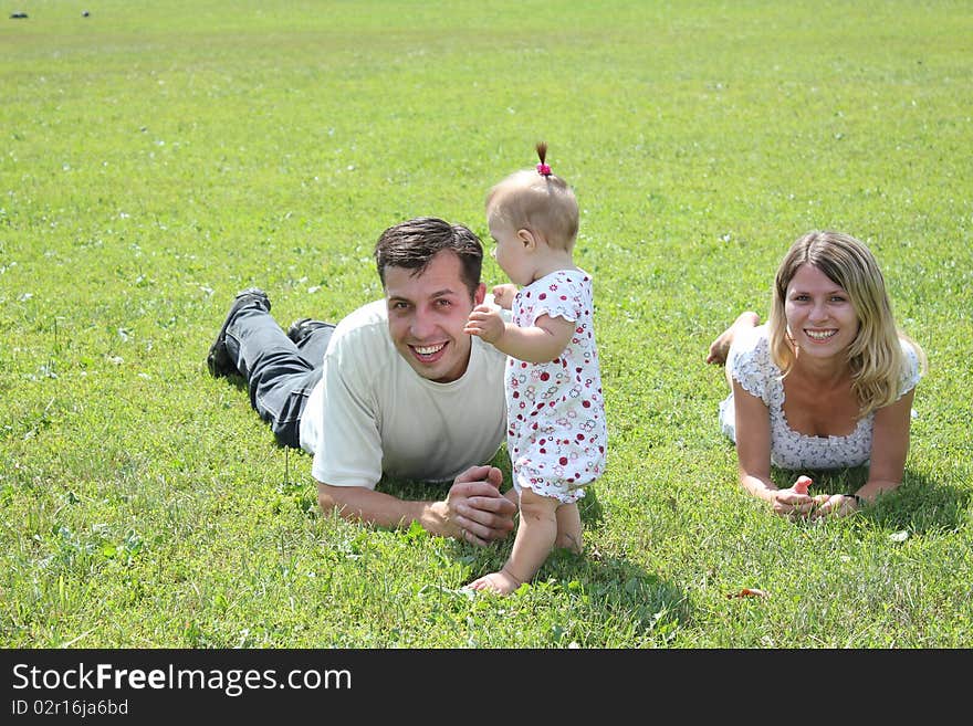 Happy family on the green grass