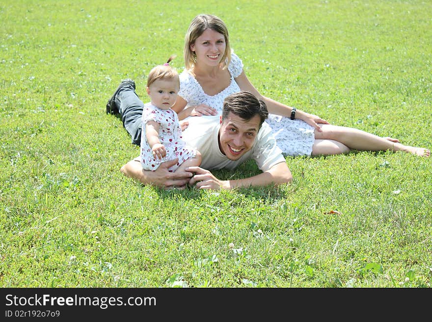 Young family on the green grass