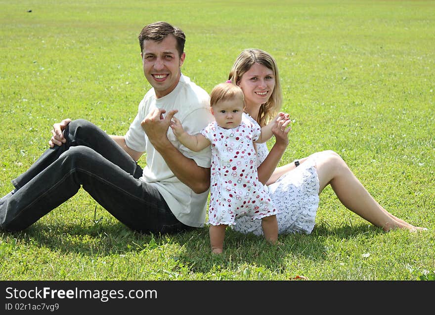 Happy family on the green grass