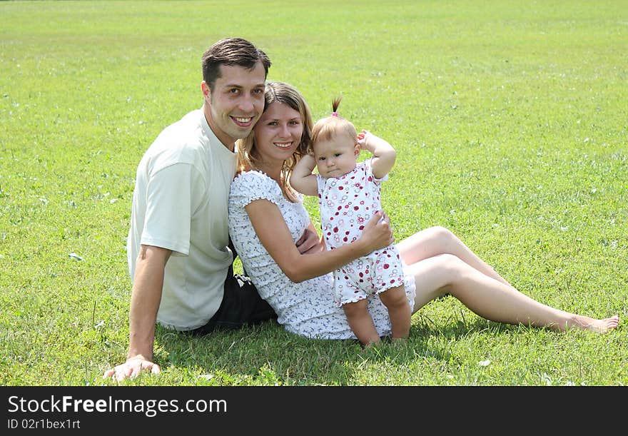 Happy family on the green grass