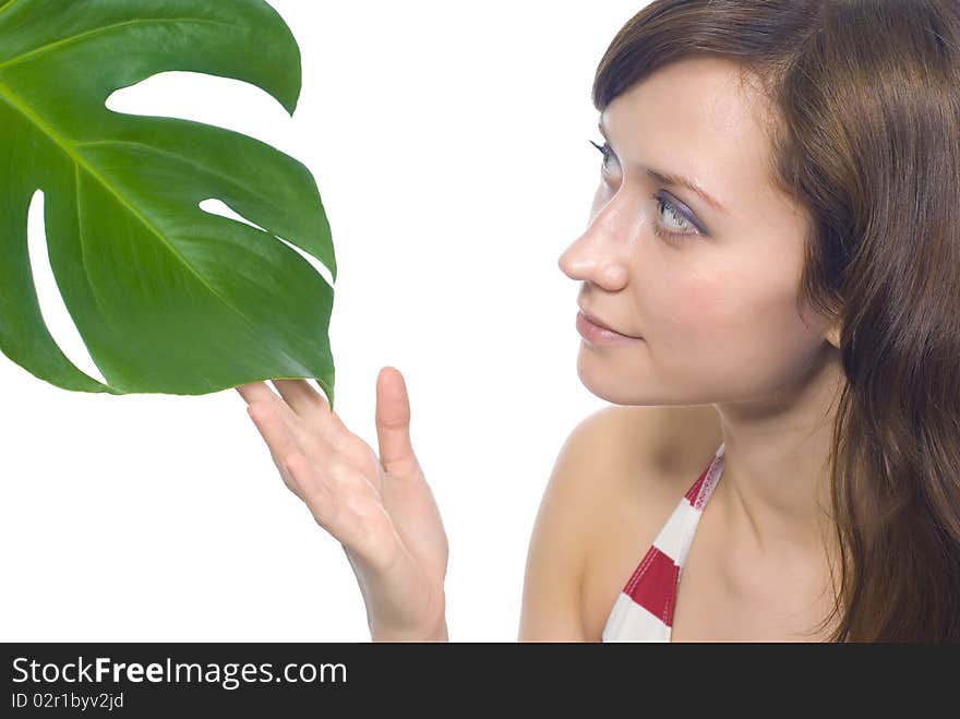 Young woman on a white background with a green leaf. Young woman on a white background with a green leaf