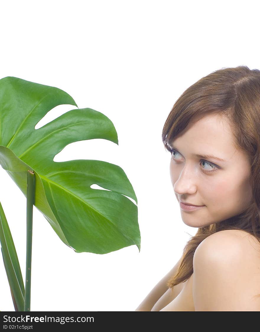 Young woman on a white background with a green leaf. Young woman on a white background with a green leaf