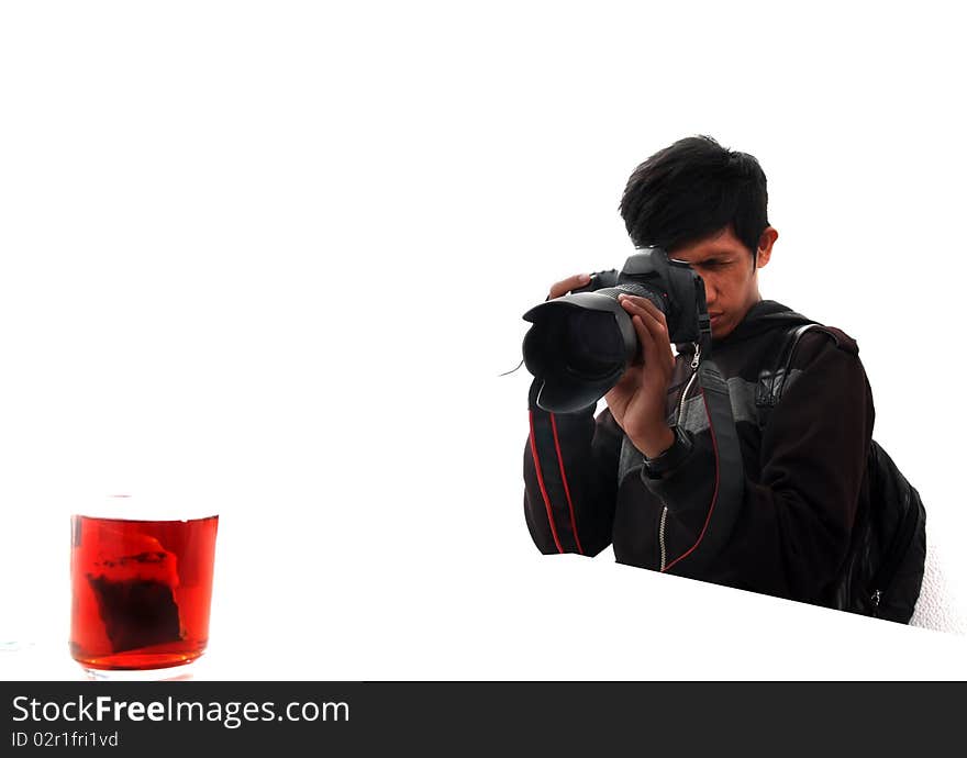 Portrait of a photographer while shooting an object tea. Portrait of a photographer while shooting an object tea