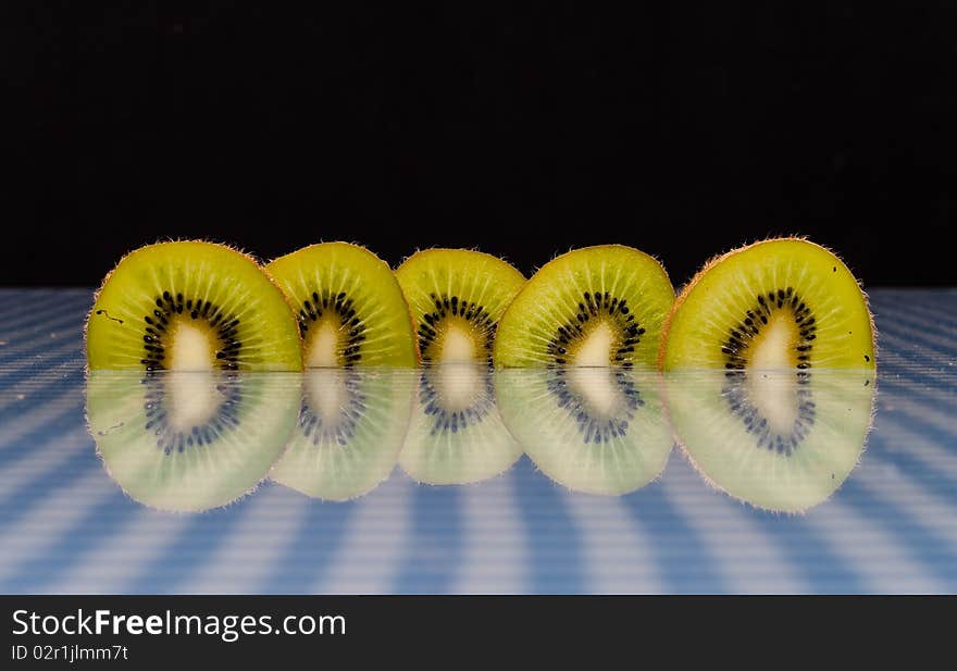 Kiwi Slices with Reflection On Picnic Cloth