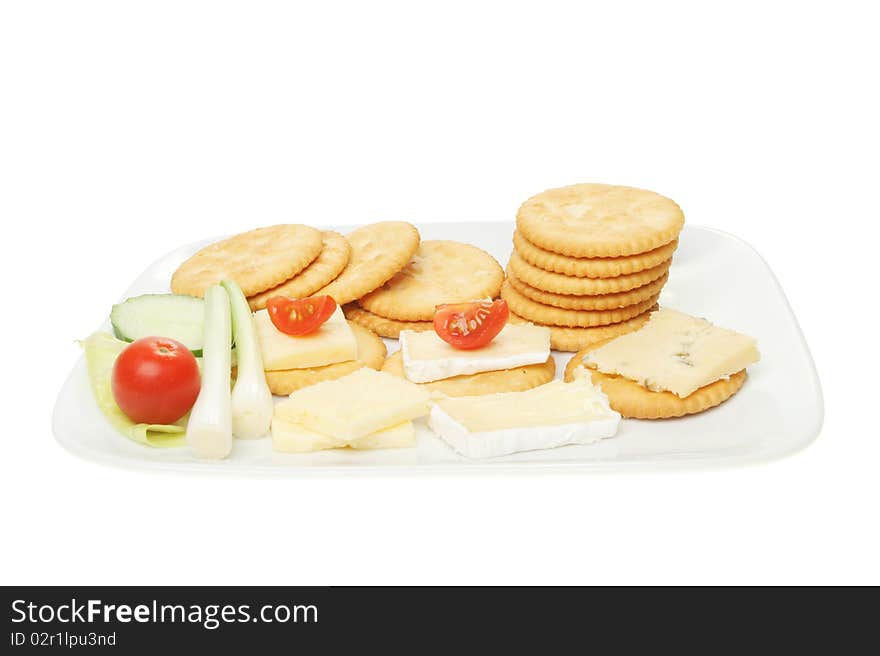 Biscuits cheese and salad on a plate isolated on white