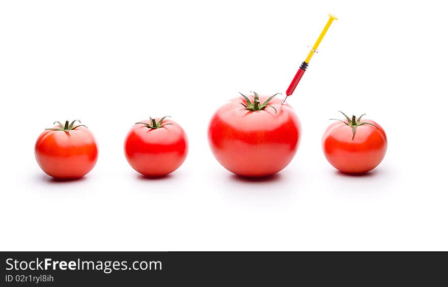 Injecting red liquid in big tomato. Useful for genetic modification concepts. Injecting red liquid in big tomato. Useful for genetic modification concepts.