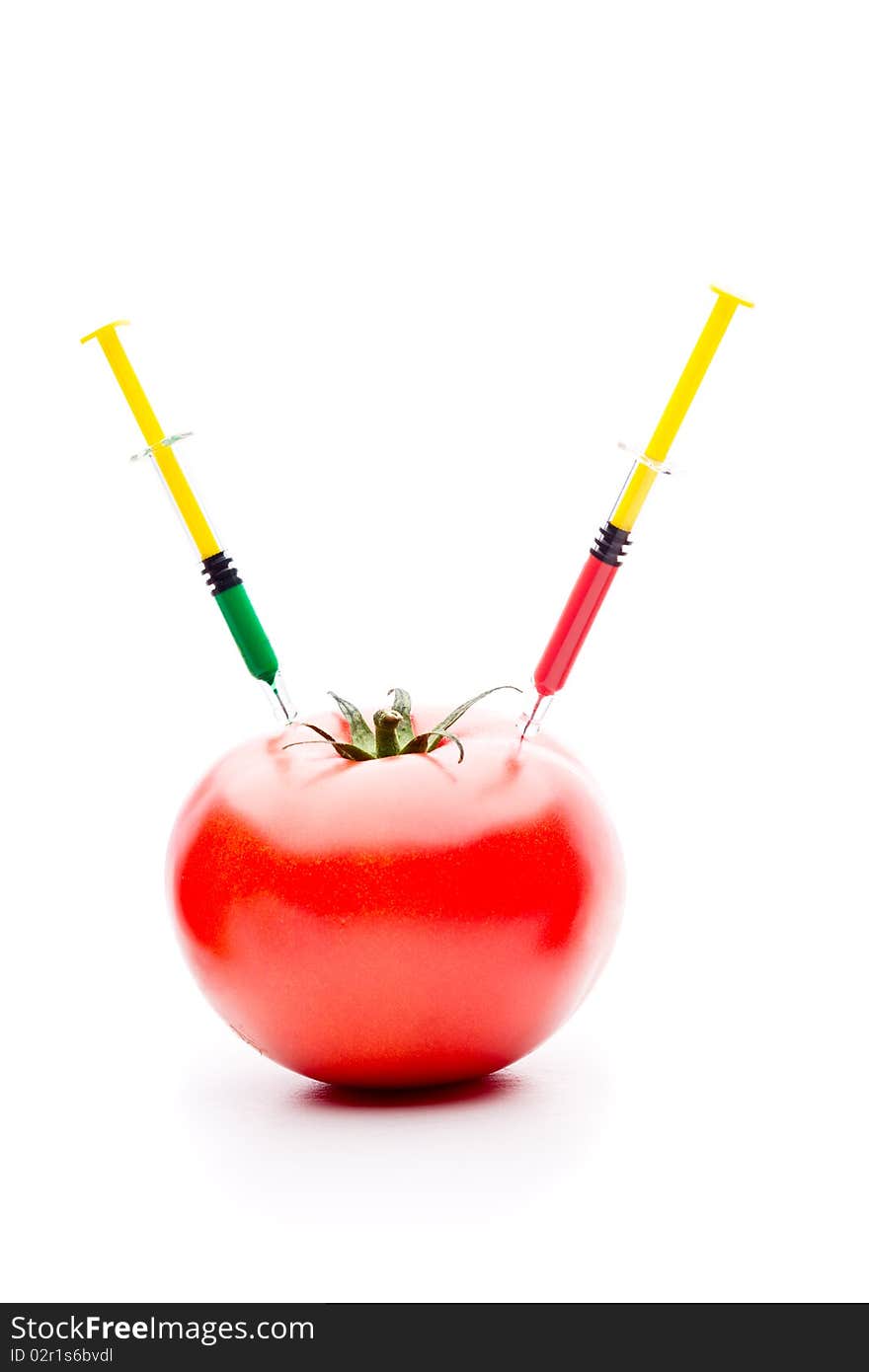 Injecting liquid in big tomato. Useful for genetic modification concepts. Injecting liquid in big tomato. Useful for genetic modification concepts.