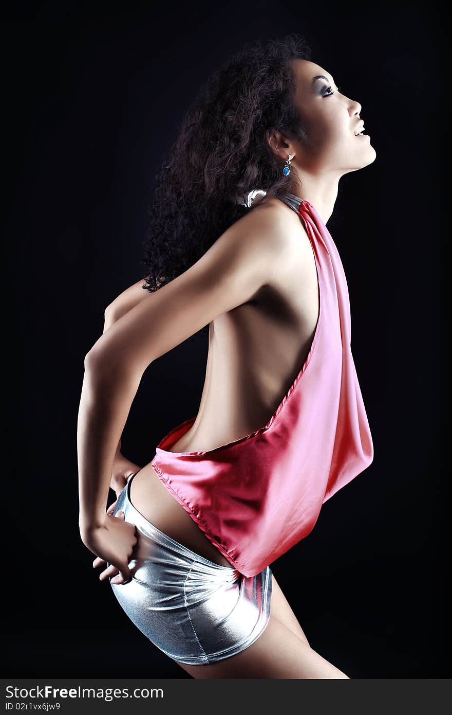 Shot of an attractive young woman posing over black background. Shot of an attractive young woman posing over black background.