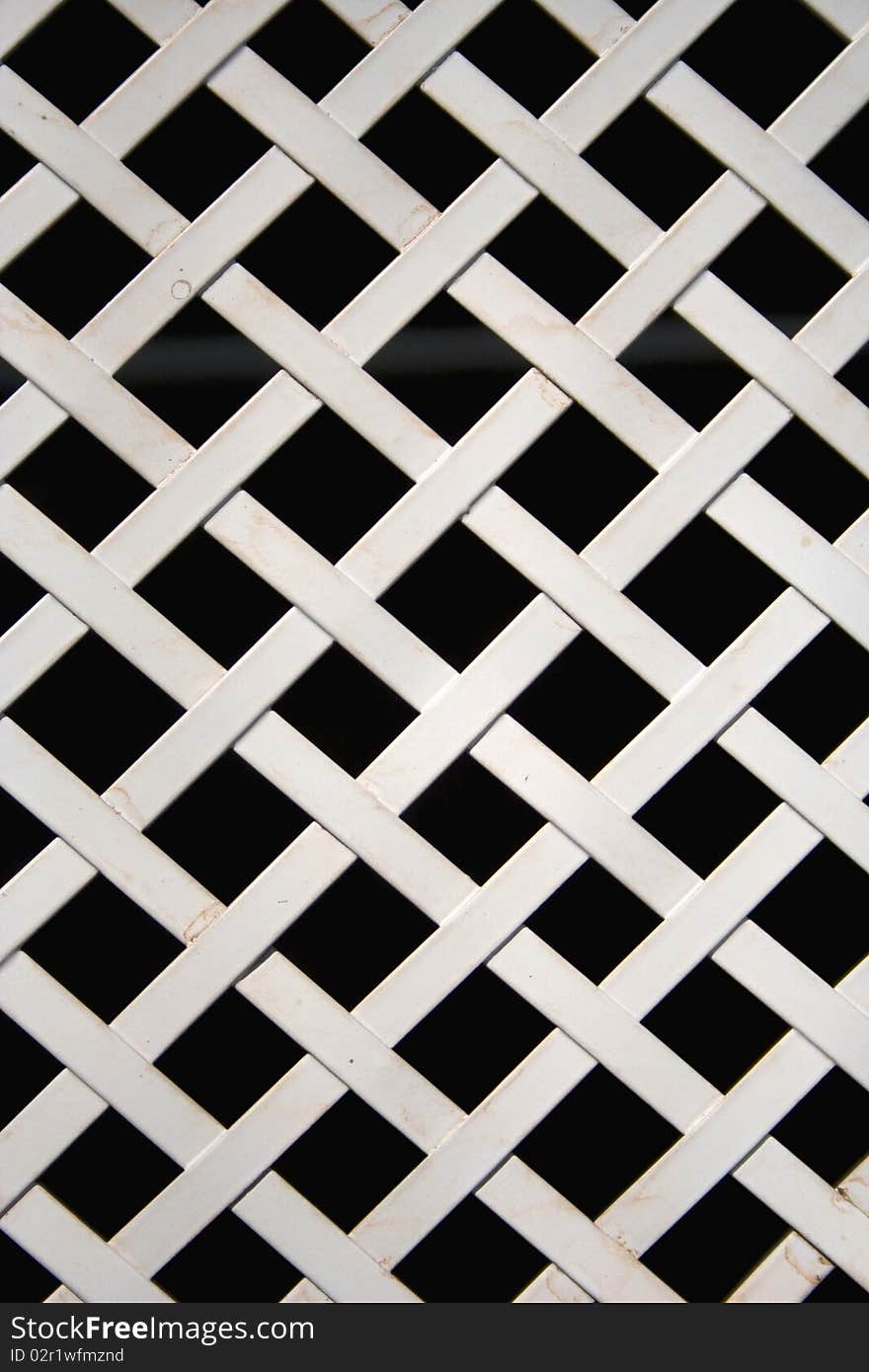 Lattice of white metal with a black background. Lattice of white metal with a black background.