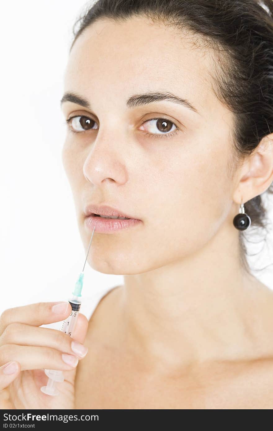 Woman puts syringe close to her lips. Woman puts syringe close to her lips