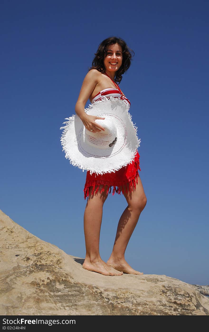 Beautiful girl on beach rock